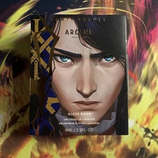 Fenty Beauty x Arcane Rogue On Riche$ Gloss Bomb Universal Lip Luminizer In Hand