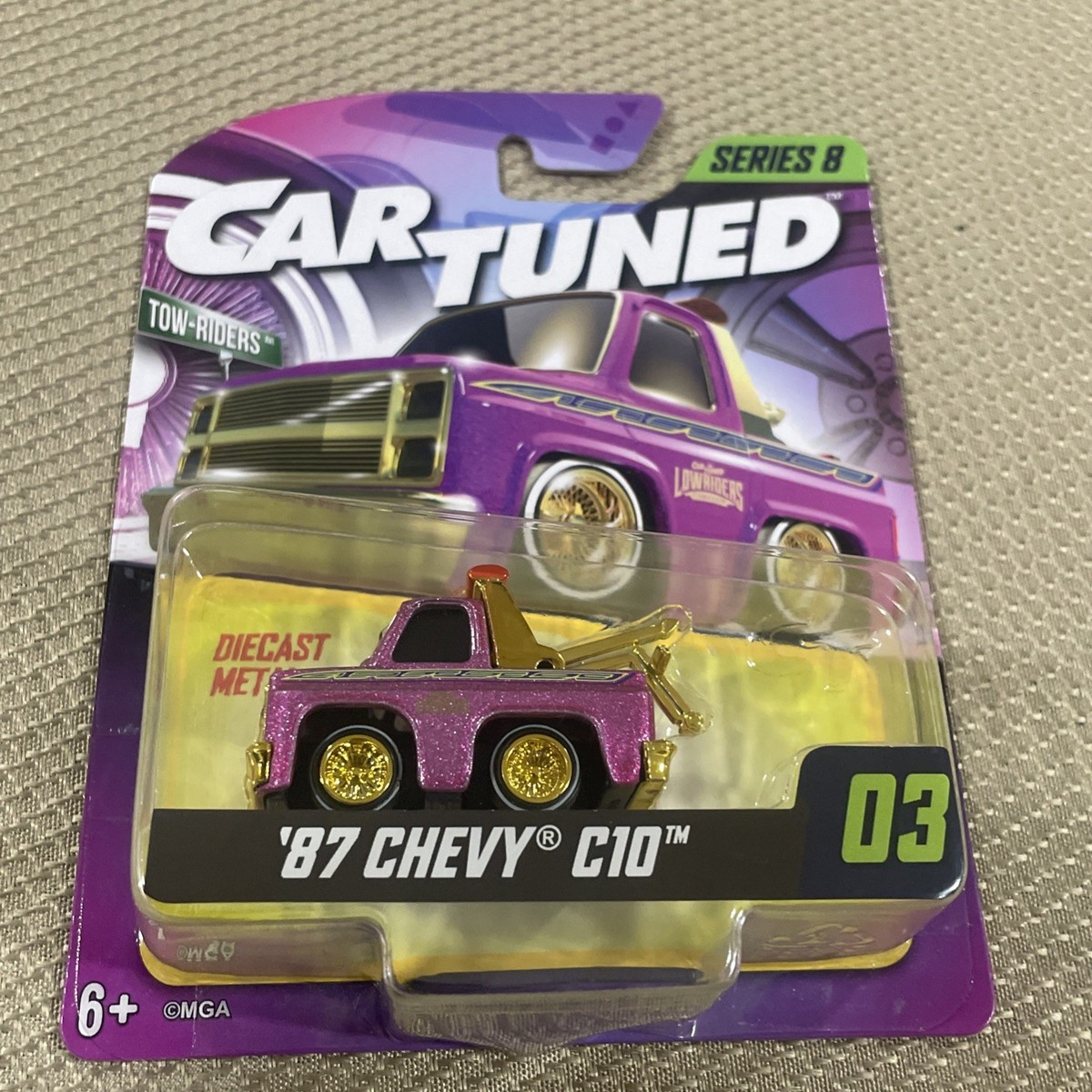 MGA Car Tuned Series 8 1:64 '87 Chevy C10 Tow Truck Purple Gold