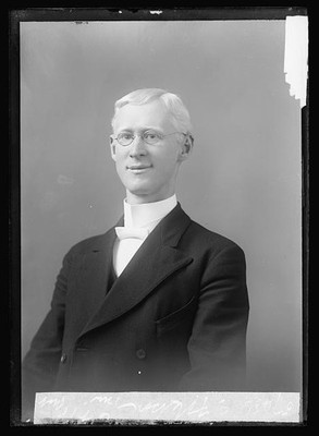 Photo:E.F. Nelson Portrait Man in Suit and Glasses