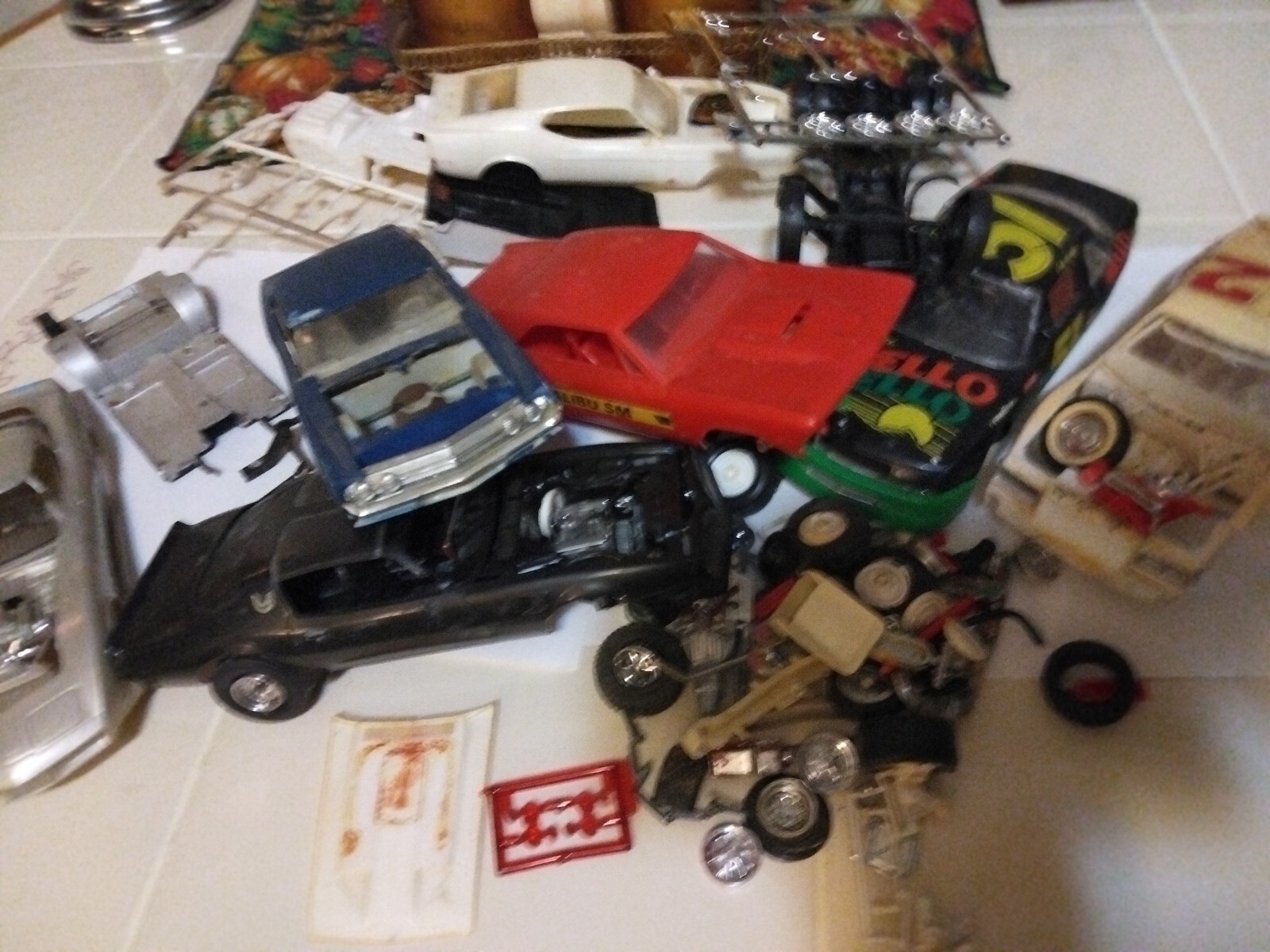 Junkyard parts lot of plastic model cars and  pieces a semi truck chassis lot.
