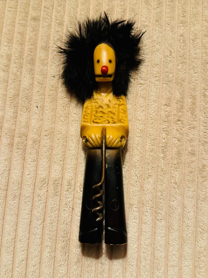 A rare Bakelite? standing-man figural corkscrew with wild big-hair styling — the kind of one-of-a-kind vintage oddity serious collectors lose sleep over.