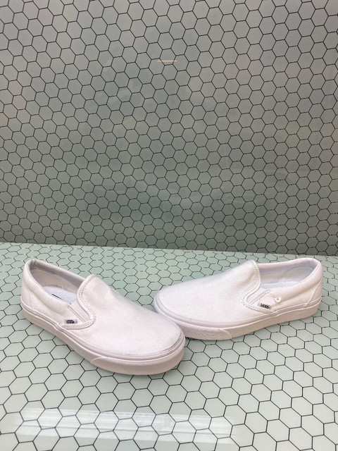 all white low top vans