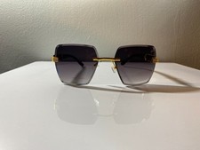 Unisex, rimless, oversized sunglasses with black  gold frame and purple lenses