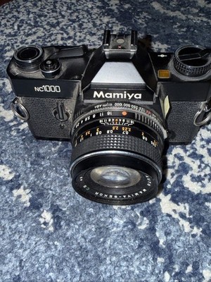 Mamiya NC1000s 35mm SLR Camera w/ 50mm f/1.7 Lens   Excellent.  No Batt Cover