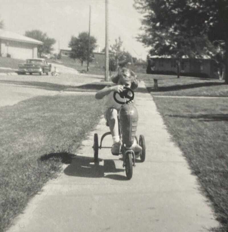 Vintage 1960s Young Girl Riding Tricycle Bike on Sidewalk Or