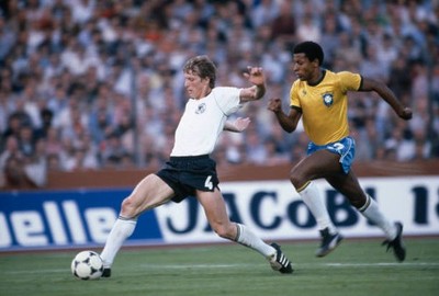 West Germany's Karl-Heinz Foerster is chased by Brazil's Cesar dur- Old Photo