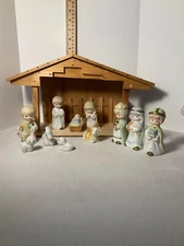 Wooden manger musical with porcelain nativity figurines
