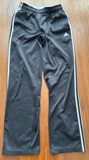 Adidas black youth track pants with white 3-stripes detailing, size XL 18 .