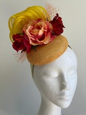 Stunning yellow fascinator with loops and red and orange flowers and netting