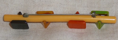1940s Bakelite bar pin. The four V sections are green, orange, gold, and black. - Picture 2 of 2
