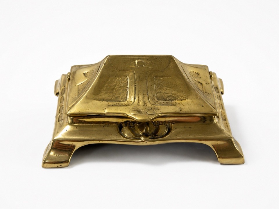 A hinged brass Art Nouveau stamp box is the kind of tiny functional sculpture that belonged on a Victorian gentleman's desk — and still earns double-takes today.