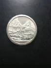 One "Swiss America" 1 One Oz Silver Round