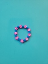 Kids blue bracelet with pink flowers. Handmade and stretchy.