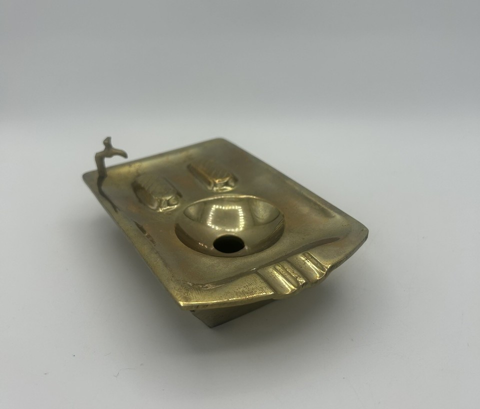 A solid brass novelty ashtray sculpted as a miniature bathtub and sink with working-look faucets — a tiny piece of absurdist vintage craft.
