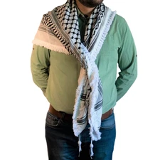 A Palestinian keffiyeh in indigo white, neatly trimmed with royal tassels.
