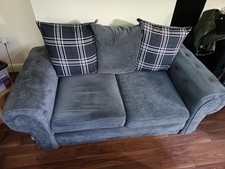 2 Seater Grey Material Sofa. Used, Good Condition.