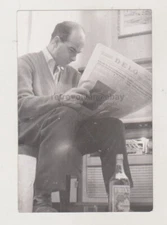 Unusual Angle Of A Man Reading A Newspaper With A Bottle In The Frame Abstract
