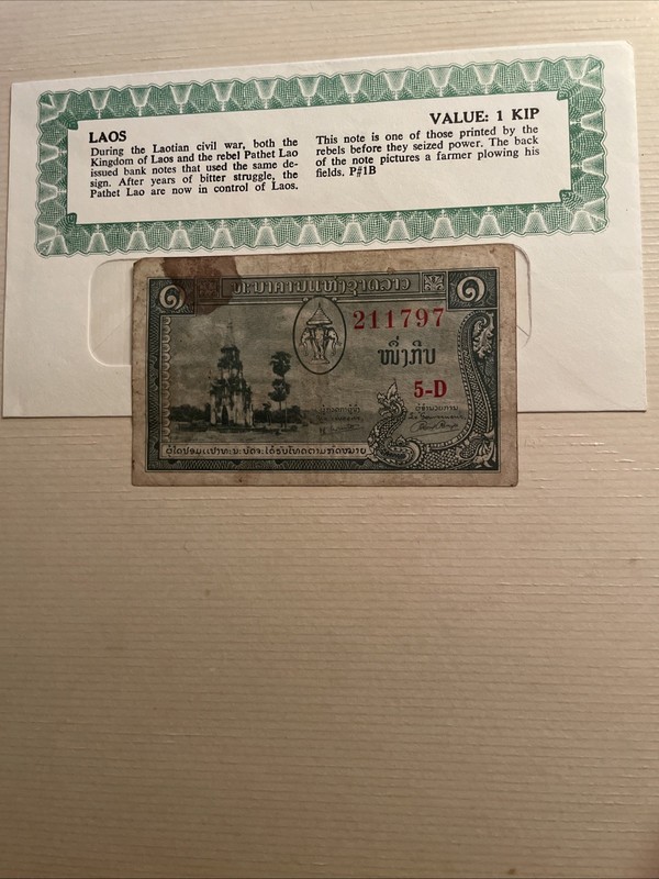 This item is a 1957 Laos 1 Kip banknote.