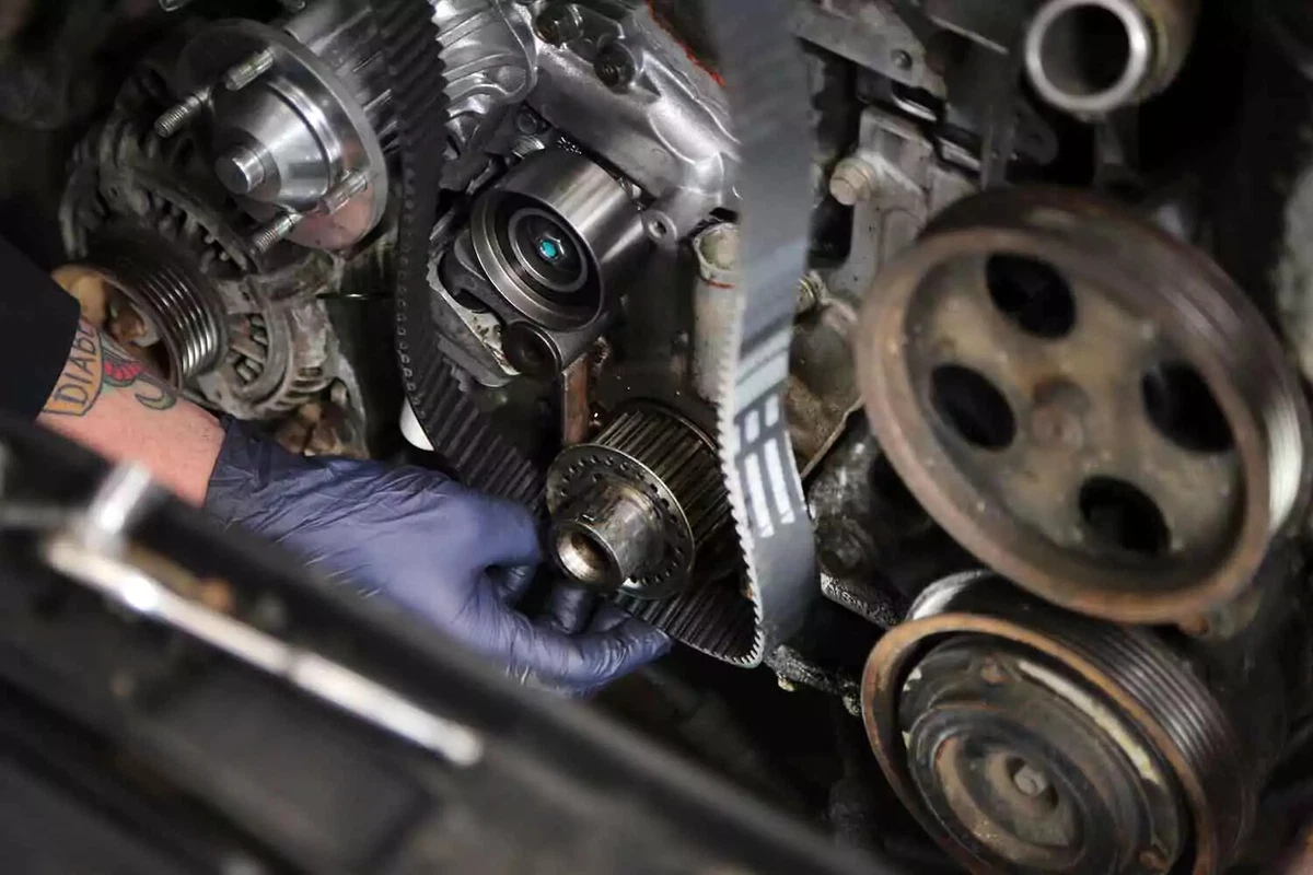 Mechanic installing a new timing belt.