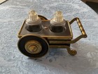 Vintage MCM salt and pepper shakers in a heavy brass and metal cart — photo 1