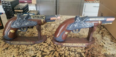 Lot of 2 Red Sippin Whiskey Gun decanter. Ezra Brooks with stand