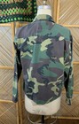 Green camouflage ranger shirt with long sleeves, button-up back, and “USA Made Medium” label on neckline.