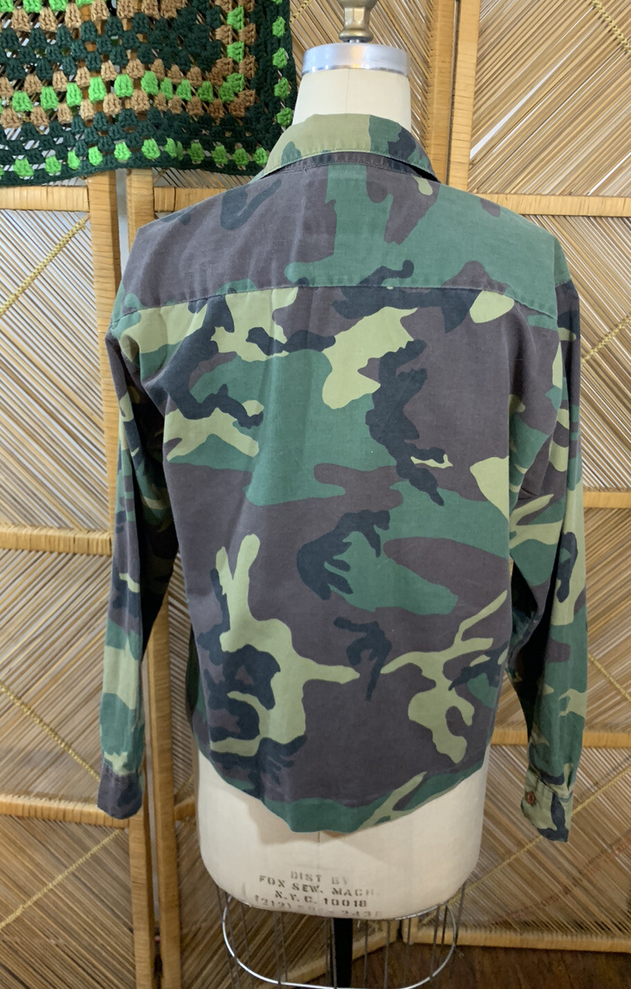 Green camouflage ranger shirt with long sleeves, button-up back, and “USA Made Medium” label on neckline.