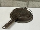 Antique Wagner Ware cast iron waffle iron with a patent date of February 1910