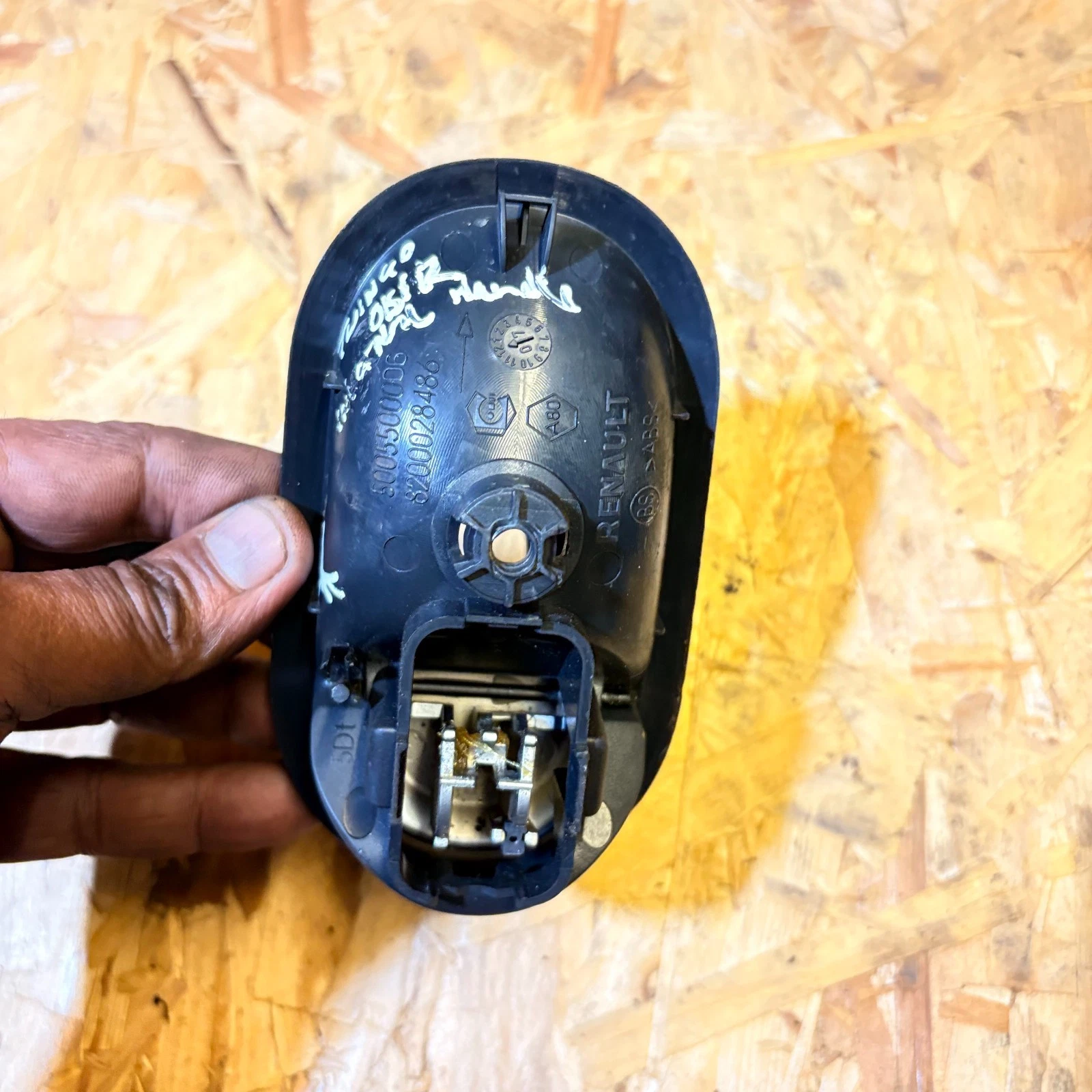 Rear of Renault interior door handle showing part reference