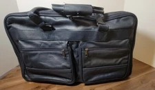 vintage leather travel bag with TH on zipper pulls 