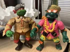 The two action figures are vintage Playmates Teenage Mutant Ninja Turtles