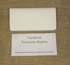 1 WHITE VINYL CHECK BOOK COVER & 1 CHECKBOOK TRANSACTION REGISTER