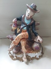  large Capodimonte tramp on bench Figure 9 1/2 inch long cx 11 inch tall