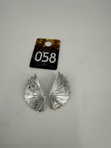 A pair of metallic, fan-shaped, pleated statement earrings.