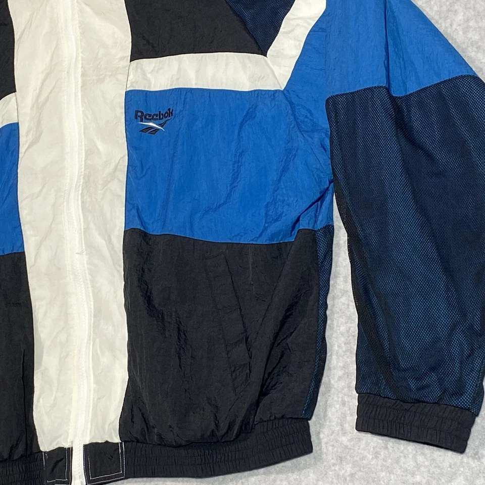Chaqueta cortavientos vintage Reebok para hombre grande azul marino blanco bloque de color cremallera completa años 90 Foto 2 de 4