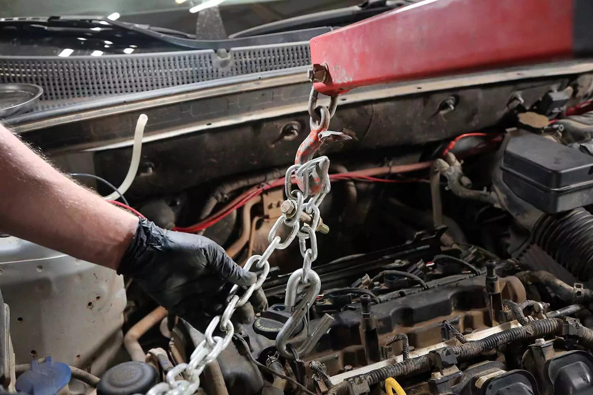 Engine hoist chained to the factory engine lifting eyelet.