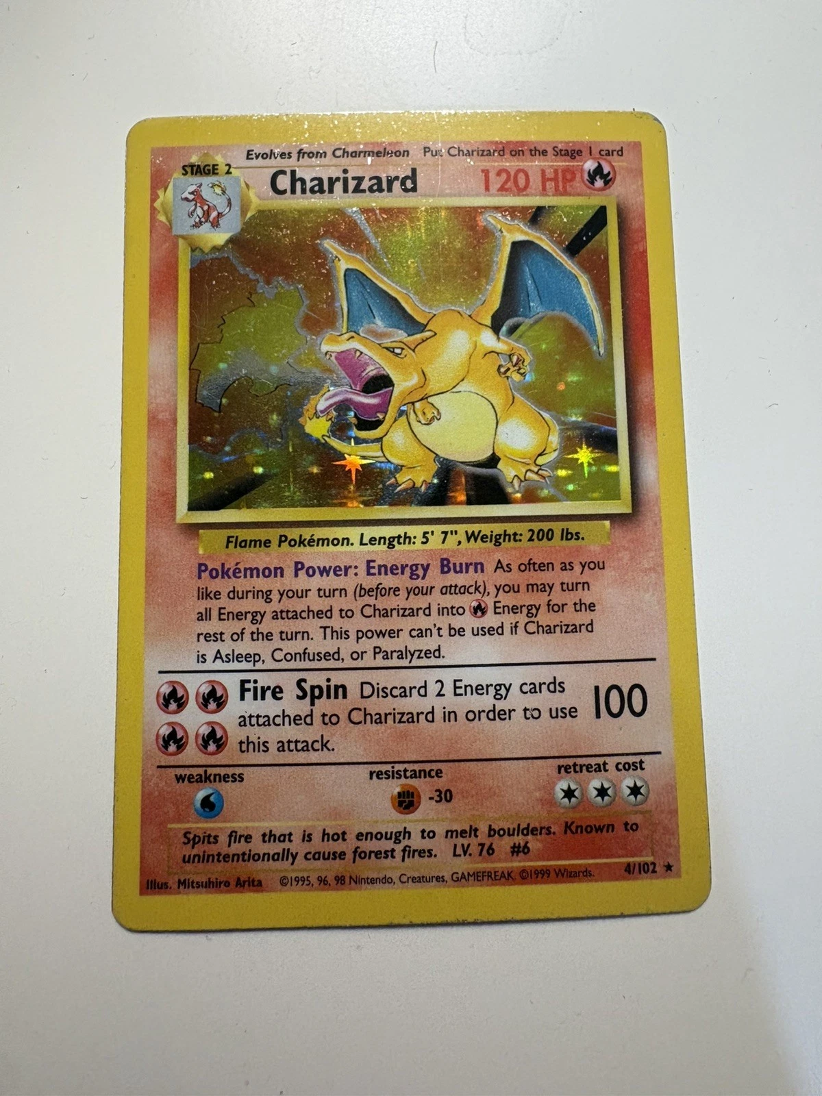 A raw Charizard card photographed flat