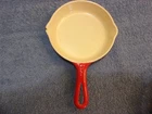 Vintage Griswold #0 enameled cast iron skillet. Red and cream.