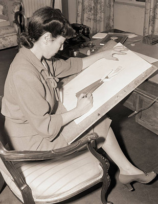 Paramount dress designer Edith Head shown here sketching details - 1940 Photo