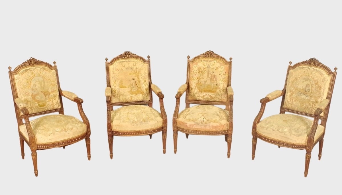 Four Louis XVI style armchairs upholstered in petit point tapestry