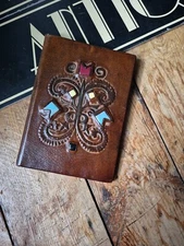 Old vintage Arts and Crafts style tooled leather wallet with inset stones 
