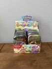 Prismatic Evolutions - Set of 8 Sealed Mini Tins w/ Open Display Box