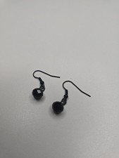 earrings large faceted black beads and smaller beads on a stem hoop.