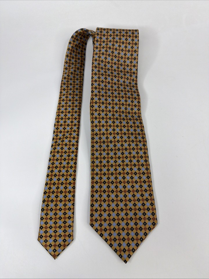 A genuine Italian-made Gianni Viera silk tie with bold gold geometric pattern — the kind of retro menswear piece that looks intentional and sharp, not thrifted.