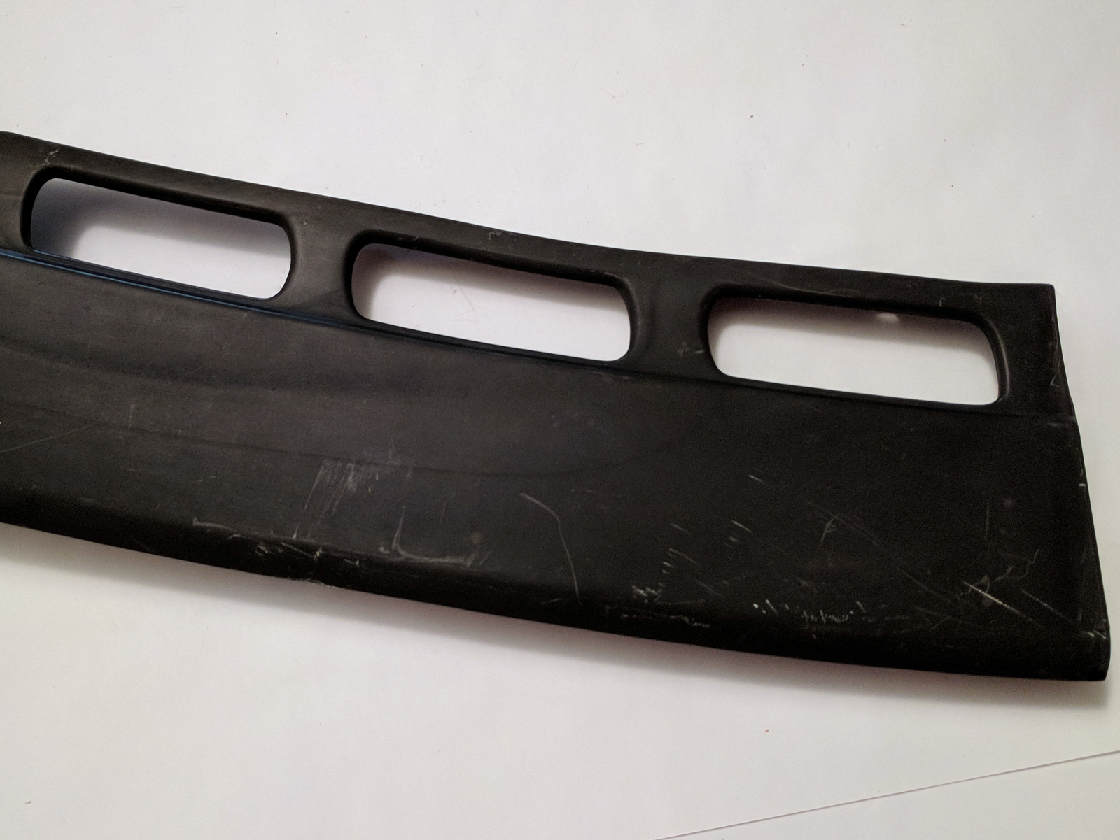 Genuine BMW E28 Bumper side plastic extension. Passenger. Front  