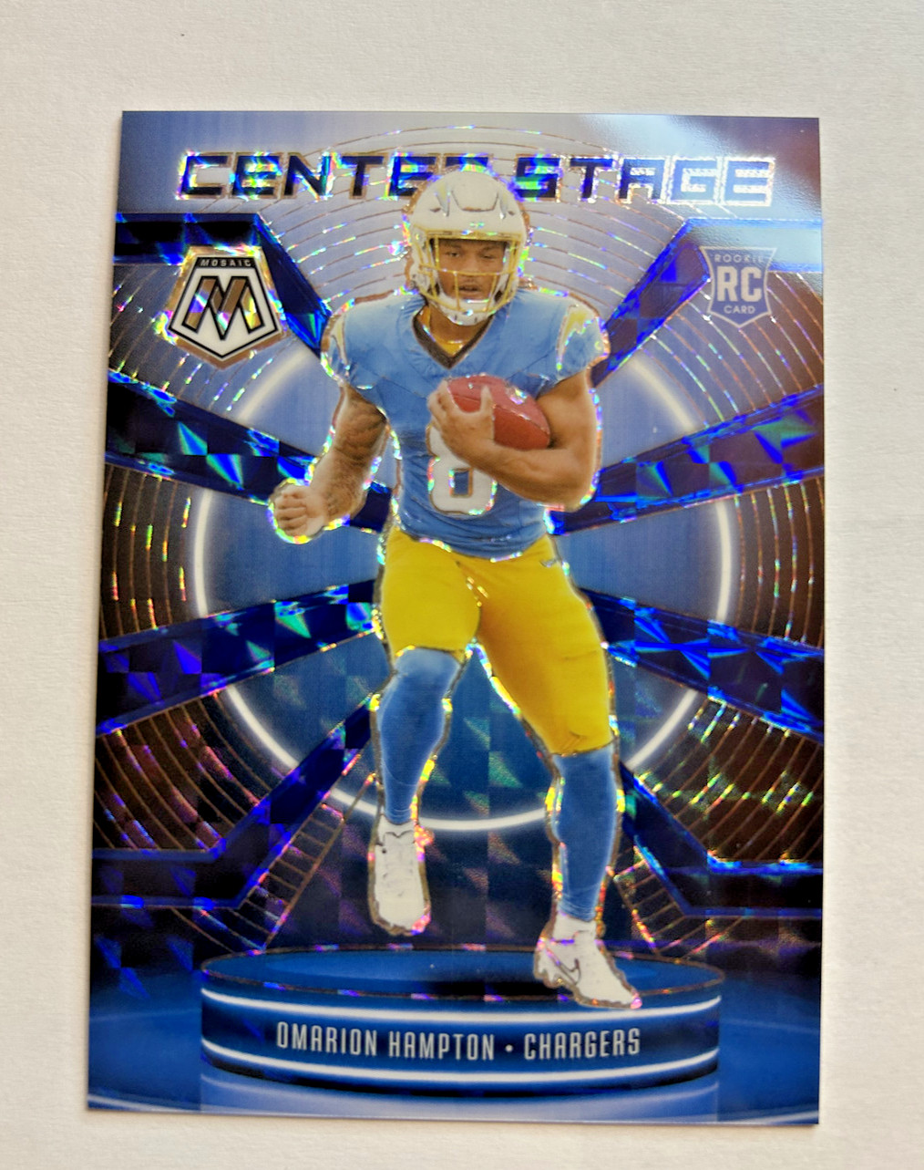 2025 Panini Mosaic - Center Stage Mosaic Omarion Hampton #6 Blue Prizm /99 (RC)