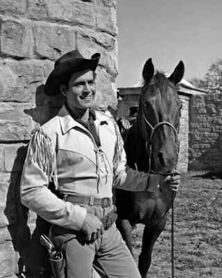 Clint Walker in fringed western jacket holding horse as Cheyenne 24x36 Poster