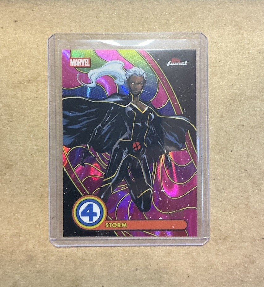 2026 Topps Finest Marvel Storm #BL-083 Blacklight Neon Purple Refractor SP 72/75