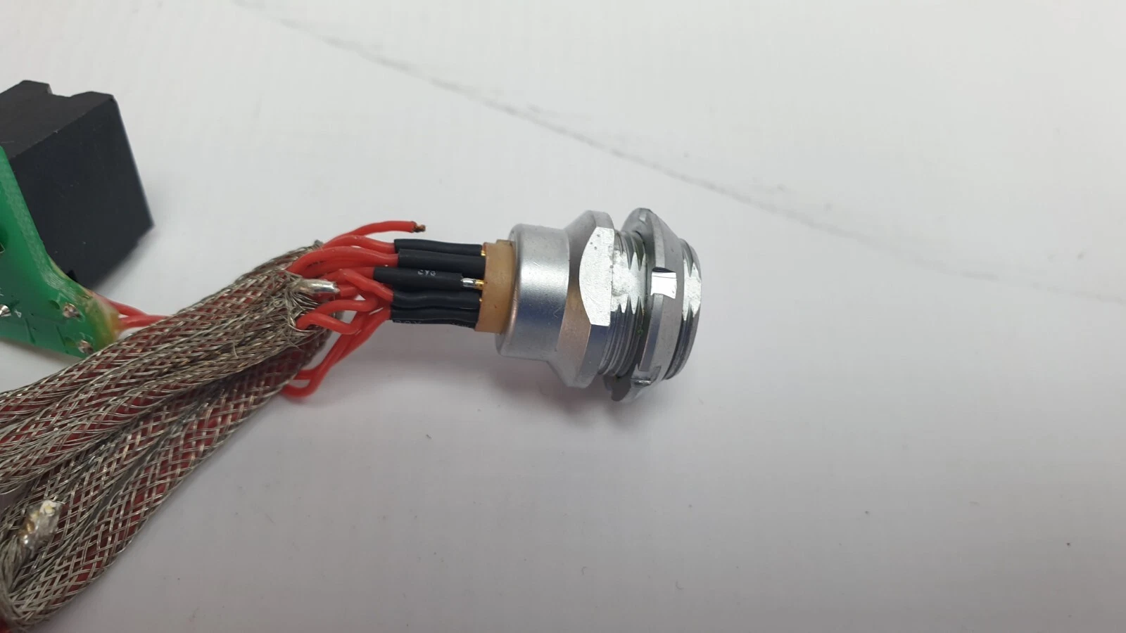 Side of the circular panel socket with threaded body and fixing nut