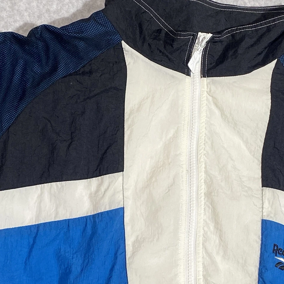 Chaqueta cortavientos vintage Reebok para hombre grande azul marino blanco bloque de color cremallera completa años 90 Foto 3 de 4